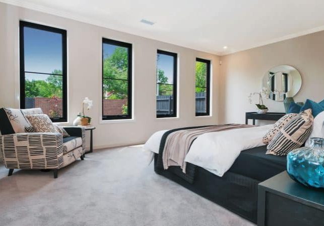 Four-Black-Aluminium-Awning-Windows-in-a-bedroom